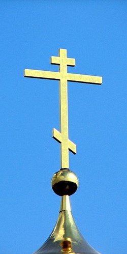 The purity of the Russian Orthodox Cross against a bright blue sky is not reflected in the murky alliance through which it is supporting Putin's murderous assault on Ukraine